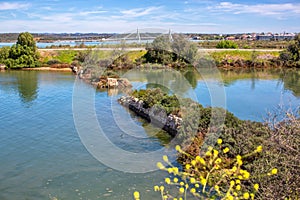 A small lake in the city of Portimao overlooking the new bridge and mountains