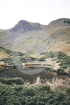 A small lake at the foot of the mountain. photo of the lake. calm water in the lake