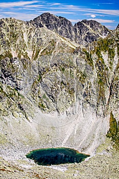 Small lake and high peaks in mountains