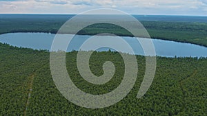 A small lake in a large Siberian forest. Aerial view.