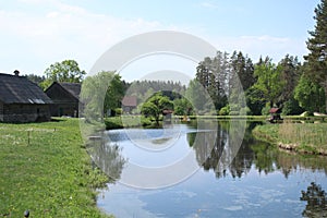 Small lake on the outskirts of the Latvian farm at the end of May 2019 photo