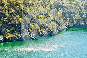 A small lake in a quarry , extracting minerals, rock