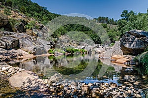 Small lake reflecting the environment in the Natural Park of Las Batuecas, Salamanca, Spain photo