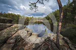 small lake among rocks and forest on a sunny autumn day. The famous Devil Lake in Karkaralinsk in Kazakhstan