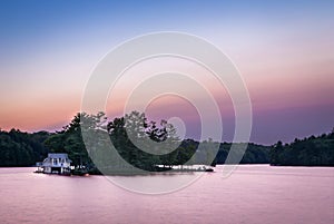 A small lakeside cottage on an Island in the Muskokas, Ontario, at sunrise.