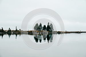 Small land peninsula or breakwater into Lake Superior, with a calm reflection on the water, in Grand Marais, Minnesota photo