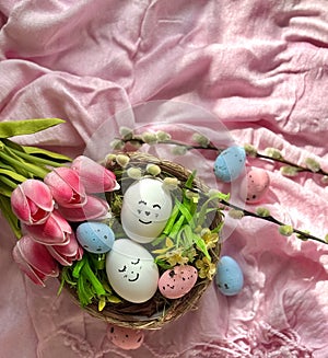 Small and large Easter eggs in a wicker nest