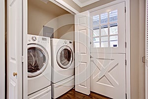 Small laundry area with washer and dryer. photo