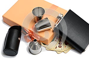 Small leather hip flask with metal mugs and pocket and funnel at orange giftbox