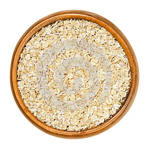 Oatmeal, rolled white oats in wooden bowl