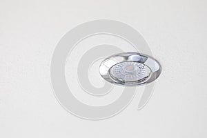 Small led spotlight illuminating white ceiling