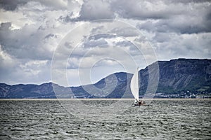 Small leisure sailing boat on Menai Straits in Anglesey Wales wi