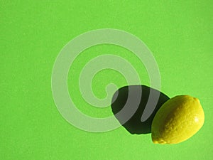 Small lemon on green background photo