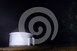 Small lighten chapel in evening in mountaines