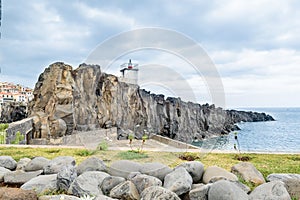 The small lighthouse Farol de Camara de Lobos, built on top of a promontory. Madeira, Europe