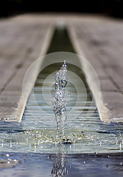 A small little fountain in the middle of the ground