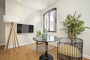 Small living room with tv and black round table