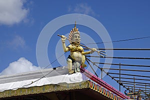 A small Lord Shiva statue at the roof of one of many Hindu temples in Mauritius