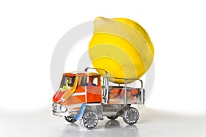 Small lorry loaded with one big lemon