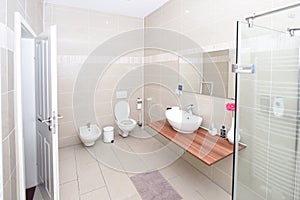 small but luxury bathroom, mirror, white tiles, sink, toilet