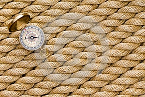 Small magnetic compass on diagonal strands of rope