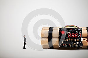 Small man looking at big bomb