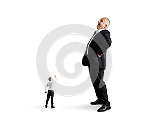 Small man showing fist to big businessman