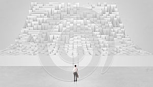 Small man standing in front of an infinity maze