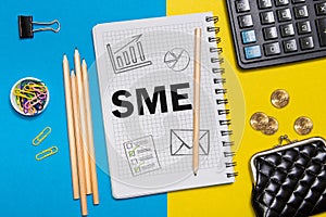 Small and Medium Enterprise, SME notes in the notebook on the Desk of a businessman in office. Business concept SME