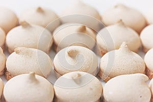 Small meringue cookies, arranged in row, selective focus
