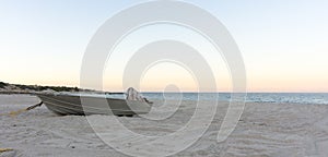 Small metal fishing boat on the beach