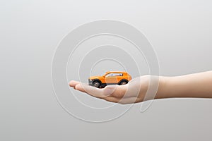 Small metal model toy car in child hand