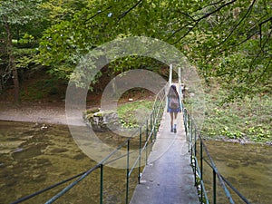 Small metallic pedestrian bridge over Cerna river, Romania, Europe