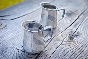 Small milk jug on old wooden table