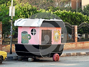 small mini mobile food market with snacks and coffee. Street Market on wheals on the aide walk of the street photo