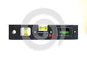 Small, mini, pocket sized spirit level. Isolated on white background. Used in construction jobs.