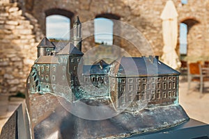Small model of the Rabsztyn Castle with real building in the background