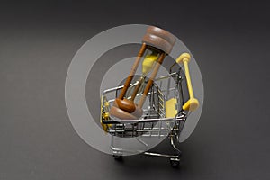 Small model shopping cart over black background studio