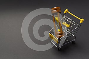 Small model shopping cart over black background studio