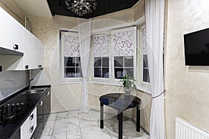 Small modern kitchen in apartment with granite worktop