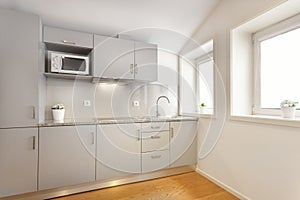 Small and modern kitchen with grey cupboards