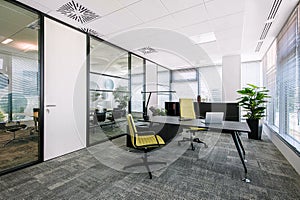 Small modern office boardroom and meeting room interior with desks, chairs