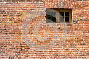 Small modern plastic window on vintage old brick wall