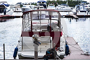 Small motor boat at anchor by rope in Replot pier