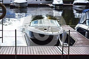 Small motor boat at anchor by rope in Replot pier