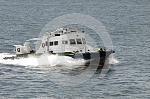 Small motor boat speeds by sea