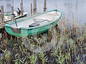 Small motor boat on a wooden landing stage