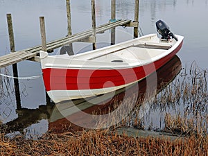 Small motor boat on a wooden landing stage