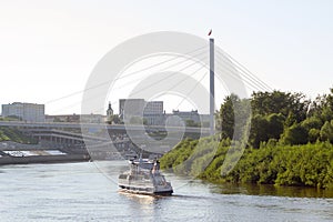 The small motor ship floats with passengers down the river Tura