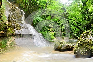 Small mountain creek with waterfall at the Abkhazian forest, Kodori gorge
